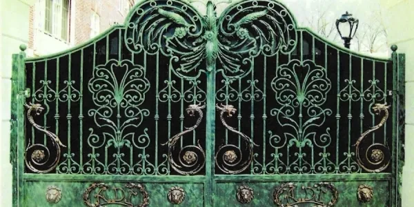 Ornate green wrought iron gate with intricate designs